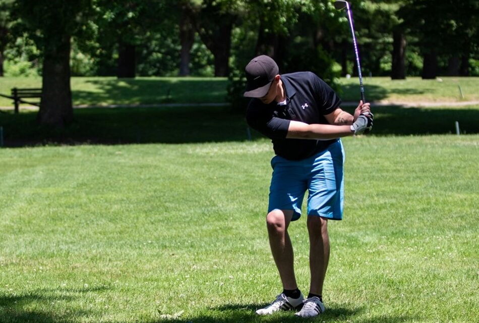 Man during backswing with shot on fairway