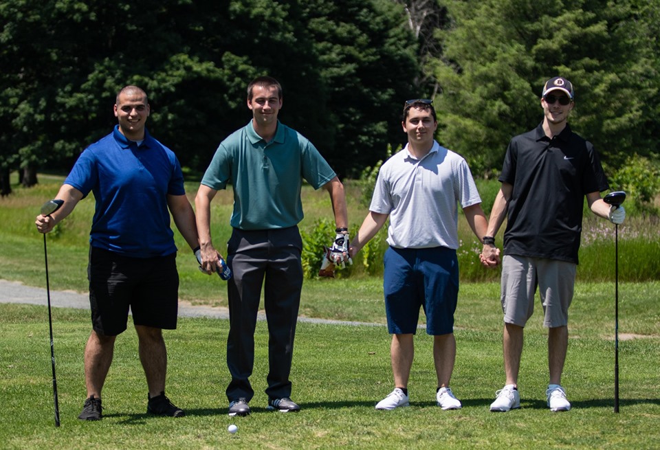 Male golfers holding hands