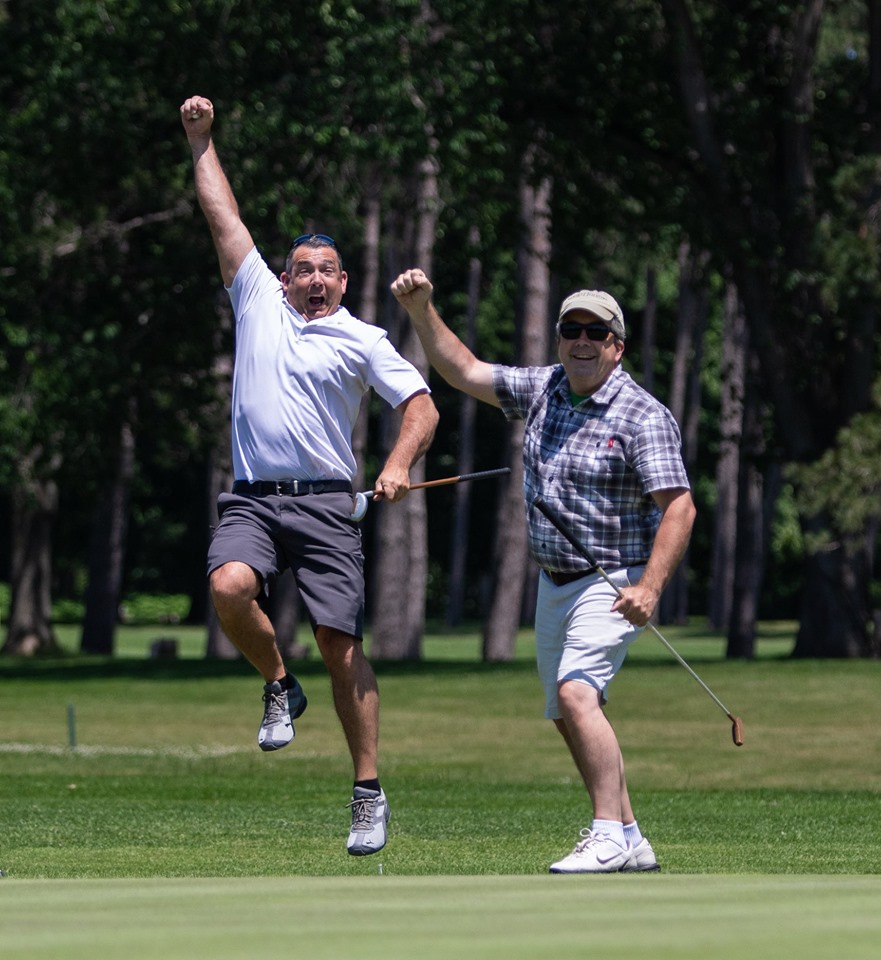 Excited pair of Golfers cheering on golf course